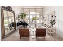 Stylish living room featuring a piano, modern furniture, large window with natural light, and hardwood floors at 2505 E Lehi Rd # 16, Mesa, AZ 85213