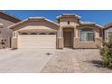 Inviting single-story home featuring a two-car garage and low-maintenance desert landscaping at 2794 E Cowboy Cove Trl, San Tan Valley, AZ 85143