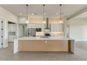 Open-concept kitchen with granite counters, stainless appliances, and modern pendant lighting at 31505 N 166Th Pl, Scottsdale, AZ 85262