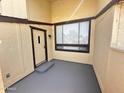 Covered front patio with a cream colored door and gray painted floors at 3646 N 69Th Ave # 70, Phoenix, AZ 85033