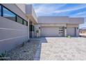 Modern home showcasing a dual-car garage, desert landscaping, and a neutral color palette for elegance at 37200 N Cave Creek Rd # 1019, Scottsdale, AZ 85262