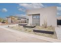 Landscaped front yard with desert plants leading up to a modern home at 37200 N Cave Creek Rd # 1019, Scottsdale, AZ 85262