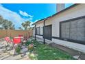 Backyard patio area with stone flooring and a seating area with a table and four chairs at 3827 N 88Th Ln, Phoenix, AZ 85037