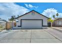 Front view of the garage showcasing the driveway and architectural details at 3827 N 88Th Ln, Phoenix, AZ 85037