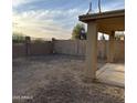 A fenced backyard with a covered patio at 4136 N 113Th Dr, Phoenix, AZ 85037