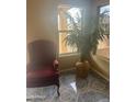 Bright sunroom with tile flooring, a large window, and an accent chair creates a cozy and inviting space at 4136 N 113Th Dr, Phoenix, AZ 85037