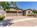 Charming desert home with a three-car garage, beautiful plants, and desert landscaping at 4361 S Electron --, Mesa, AZ 85212