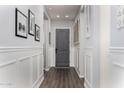 Hallway with hardwood floors, white walls, white trim, and grey doors at 4361 S Electron --, Mesa, AZ 85212