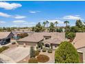 An aerial view of a well-maintained single-story home with mature landscaping and a three-car garage at 5410 E Gable Ave, Mesa, AZ 85206