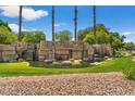 Beautiful Stonegate community entrance with a stone waterfall and lush greenery on a sunny day at 5410 E Gable Ave, Mesa, AZ 85206