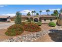 Attractive desert landscaping complements this home's exterior and includes drought-resistant plants at 5410 E Gable Ave, Mesa, AZ 85206