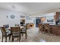 Inviting dining area flows into the kitchen, featuring a breakfast bar and ample cabinet space at 6913 W Wilshire Dr, Phoenix, AZ 85035