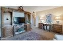 Inviting living room with a wooden entertainment center and plenty of room for relaxing and socializing at 6913 W Wilshire Dr, Phoenix, AZ 85035