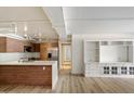 Modern open concept kitchen with stainless steel appliances, white countertops, and wooden cabinets at 7840 E Camelback Rd # 111, Scottsdale, AZ 85251