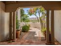 Picturesque courtyard view through an arched opening, showcasing desert landscaping and mountain views in the background at 7921 N 54Th St, Paradise Valley, AZ 85253