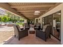 Comfortable outdoor patio featuring stylish wicker furniture and a covered space, perfect for relaxing and entertaining guests at 7921 N 54Th St, Paradise Valley, AZ 85253