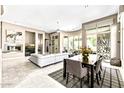 Bright, open-concept living room with modern decor, a fireplace, and floor-to-ceiling windows at 8220 E Mohawk Ln, Scottsdale, AZ 85255