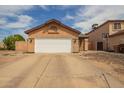 View of the front of a home with a two car garage and large driveway at 9167 N 73Rd Ln, Peoria, AZ 85345