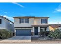 Charming two-story home featuring a well-manicured front yard with an attached two-car garage at 920 E Leslie E Ave, San Tan Valley, AZ 85140