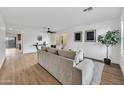 Bright living room featuring wood flooring, white walls, a ceiling fan, and neutral-toned furniture at 920 E Leslie E Ave, San Tan Valley, AZ 85140