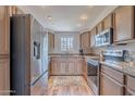 Well-lit kitchen showcasing stainless steel appliances, granite countertops, light wood cabinets, and modern finishes at 9451 E Becker Ln # 2004, Scottsdale, AZ 85260