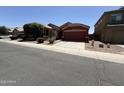 Inviting single-story home with a two-car garage and desert landscaping at 10247 W Hilton Ave, Tolleson, AZ 85353