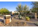 Contemporary home showcasing desert landscaping, address marker, and modern architectural design at 10283 E Running Deer Trl, Scottsdale, AZ 85262