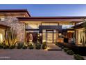 Stunning modern home featuring a water feature, desert landscaping, and architectural stone accents at 10283 E Running Deer Trl, Scottsdale, AZ 85262