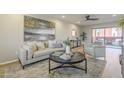 Bright living room with stylish furniture, decor, and a view of the outdoor patio at 12222 N Paradise Vlg S Pkwy # 237, Phoenix, AZ 85032