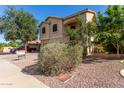 Two-story home with a two-car garage, neutral colors, and low-maintenance desert landscaping at 12571 W Clarendon Ave, Avondale, AZ 85392