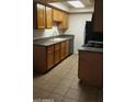 Efficient kitchen with wood cabinets, granite counters, and black appliances at 1336 E Mountain View Rd # 209, Phoenix, AZ 85020
