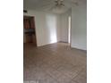 Open-concept living room featuring tile flooring and view into kitchen at 1336 E Mountain View Rd # 209, Phoenix, AZ 85020
