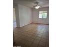 Spacious living room featuring a ceiling fan, tile flooring, and natural light at 1336 E Mountain View Rd # 209, Phoenix, AZ 85020