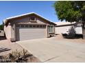 A well-maintained front yard with a spacious driveway leading to an attached two-car garage at 1384 E Las Colinas Dr, Chandler, AZ 85249