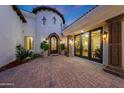 Elegant entryway with decorative ironwork, stylish sconces, and well-maintained brick paved courtyard at 1423 E Beverly Ln, Phoenix, AZ 85022