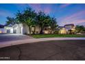 Beautiful home exterior showcasing lush landscaping and a paver driveway leading to the garage at 1423 E Beverly Ln, Phoenix, AZ 85022