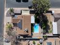An aerial view of a single-Gathering home showing the swimming pool in the backyard at 1720 E Intrepid Ave, Mesa, AZ 85204