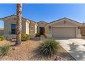 Beautiful front of the home featuring desert landscaping, a covered porch, and a two-car garage at 17517 W Dahlia Dr, Surprise, AZ 85388