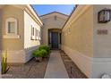 Inviting front entryway with desert landscaping and a covered walkway at 17517 W Dahlia Dr, Surprise, AZ 85388