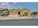 Inviting single-story house featuring a two-car garage and well-kept landscaping at 23871 N 167Th Ln, Surprise, AZ 85387