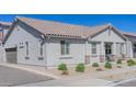 Well-maintained exterior elevation displaying neutral stucco and decorative stone accents at 25202 N 142Nd Dr, Surprise, AZ 85387