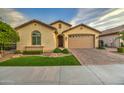 Inviting home with synthetic lawn, mature landscaping, paver driveway, a two car garage and a tile roof at 269 E Horseshoe Dr, Chandler, AZ 85249