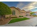 Lovely home with desert landscaping, green turf, paver driveway and a view of the two car garage at 269 E Horseshoe Dr, Chandler, AZ 85249