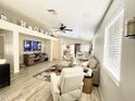 Open-concept living room with stylish furnishings, a ceiling fan, and ample natural light at 2735 E Harwell Rd, Gilbert, AZ 85234