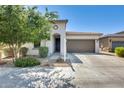 Charming single-story home with a well-manicured front yard and a two-car garage, under a bright blue sky at 2813 W Apollo Rd, Phoenix, AZ 85041