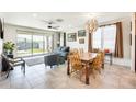 Open-concept living and dining area with tile floors, natural light, and access to the backyard at 2813 W Apollo Rd, Phoenix, AZ 85041