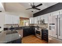 Well-lit kitchen with granite counters, stainless steel appliances and modern cabinets at 288 E Baylor Ln, Gilbert, AZ 85296