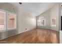 Bright living room features wood floors, large windows with bright light and high ceilings at 288 E Baylor Ln, Gilbert, AZ 85296