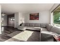 Bright living room featuring neutral décor, wood laminate floors, and large windows at 3 S 130Th Pl, Chandler, AZ 85225