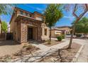 Charming two-story home boasts a welcoming stone facade and a neatly landscaped front yard at 3272 E Tyson St, Gilbert, AZ 85295